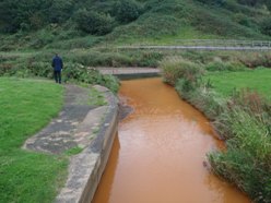 Impact of minewater on Saltburn Gill Beck approaching Saltburn beach.